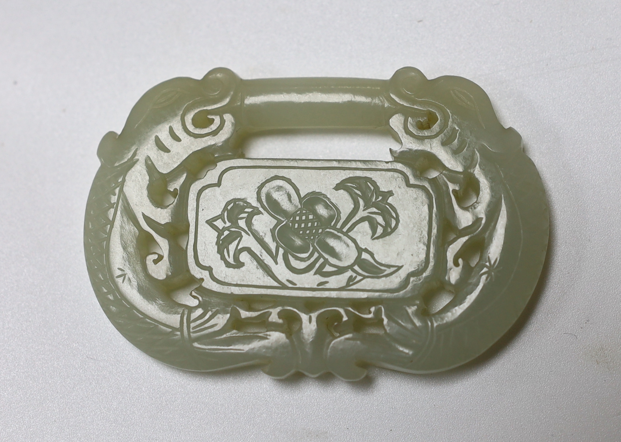 A Chinese pale celadon jade ‘lock’ pendant, 19th century